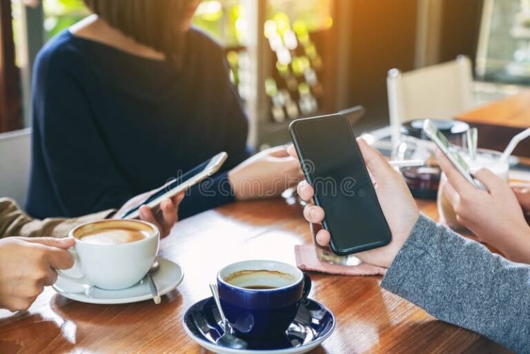 Qué app te permite ganar puntos y canjearlos por increíbles premios 11 personas usando smartphones en un cafe